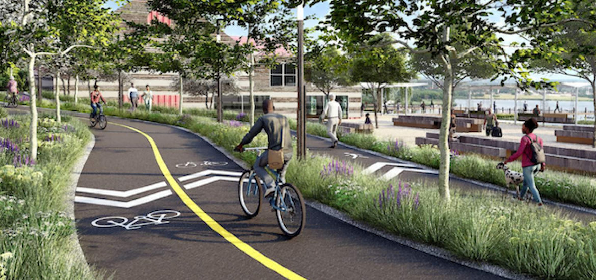 Illustrative rendering showing bicyclists and walkers along separated bike & pedestrian trails, proposed for Middle Branch Park. The scene shows generous landscaping along curving paths. The Middle Branch Boathouse is in the distance. 